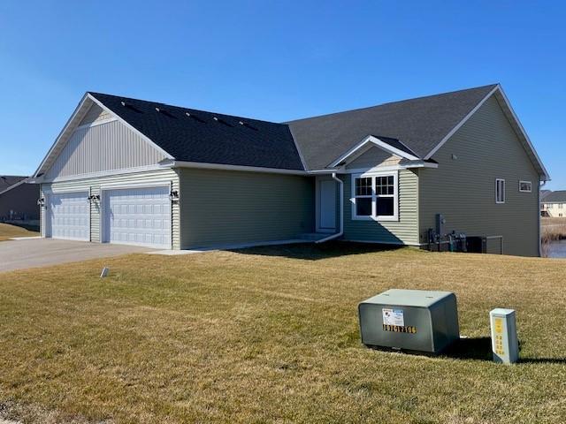 ranch-style house with a front yard and a garage