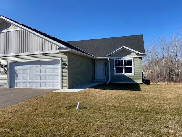 view of front facade with a front lawn and a garage