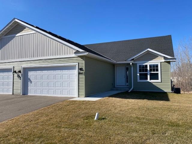 view of front of house with a front lawn and a garage