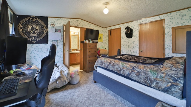 bedroom featuring wallpapered walls, vaulted ceiling, a textured ceiling, and light colored carpet