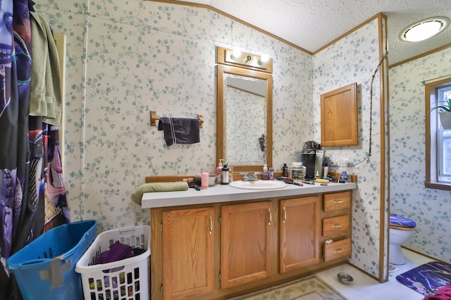 bathroom featuring lofted ceiling, wallpapered walls, toilet, and a textured ceiling