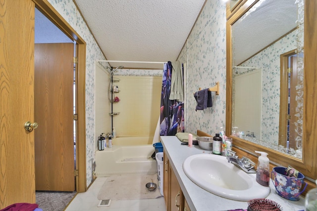 full bath featuring wallpapered walls, shower / tub combination, a textured ceiling, and vanity