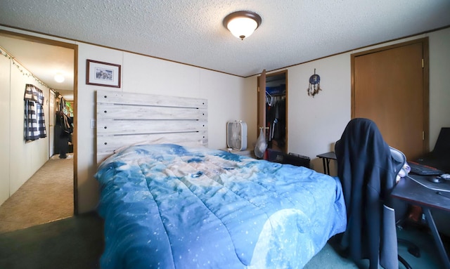 bedroom with a textured ceiling and carpet floors