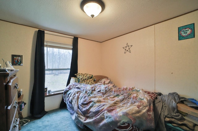 bedroom with carpet flooring and a textured ceiling