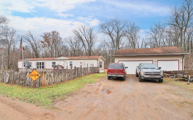 view of front of property with an outbuilding and fence