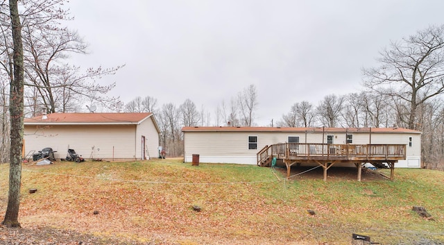 rear view of house featuring a yard and a wooden deck