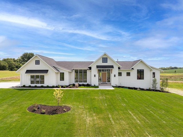 modern farmhouse style home featuring a front yard