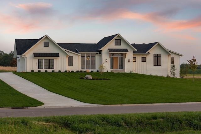 modern farmhouse featuring a lawn