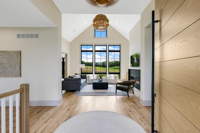 interior space with high vaulted ceiling and light wood-type flooring