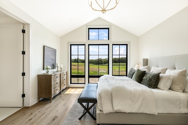 bedroom with light wood-type flooring, multiple windows, and high vaulted ceiling