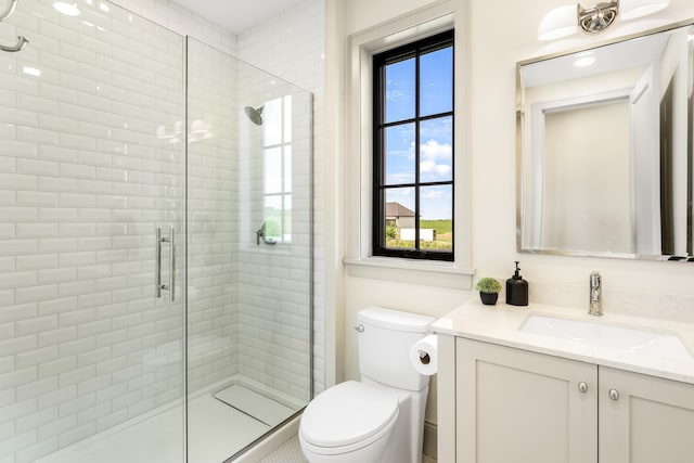 bathroom featuring walk in shower, vanity, and toilet