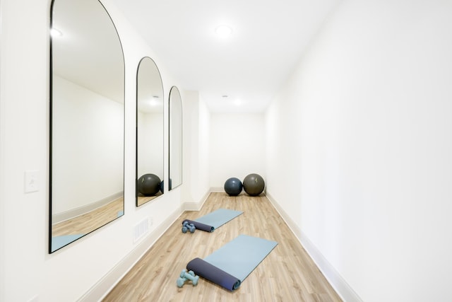 exercise area featuring hardwood / wood-style flooring