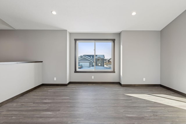 empty room with hardwood / wood-style flooring