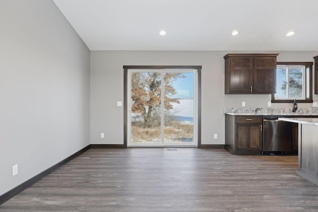 kitchen featuring dark brown cabinetry, plenty of natural light, stainless steel dishwasher, and light hardwood / wood-style flooring