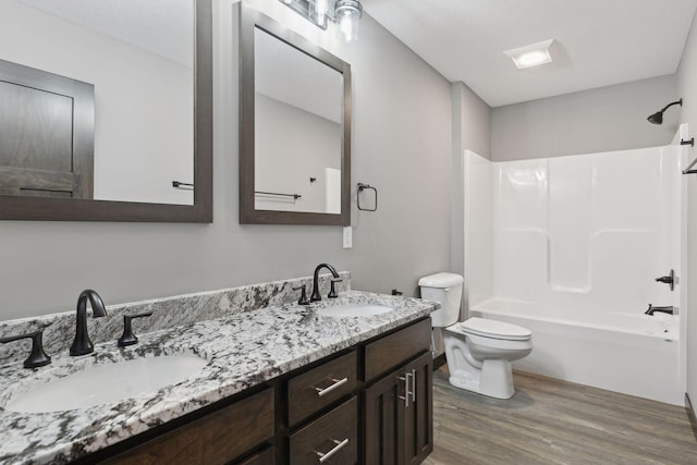 full bathroom with vanity, wood-type flooring, shower / washtub combination, and toilet