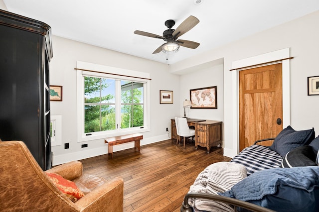 living room with ceiling fan and dark hardwood / wood-style floors