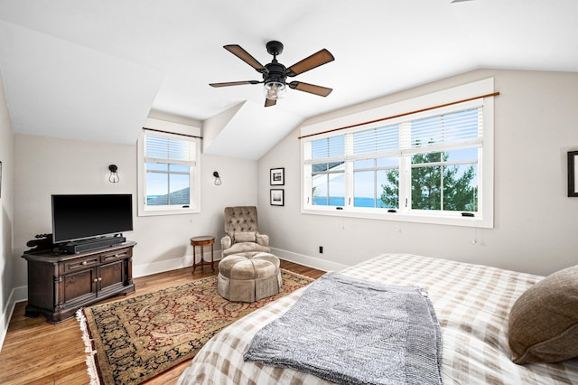 bedroom featuring multiple windows, ceiling fan, and vaulted ceiling