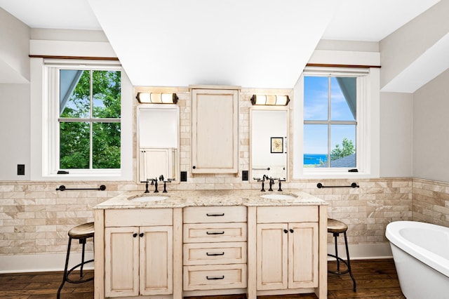 interior space with a breakfast bar area, light stone counters, and dark hardwood / wood-style flooring