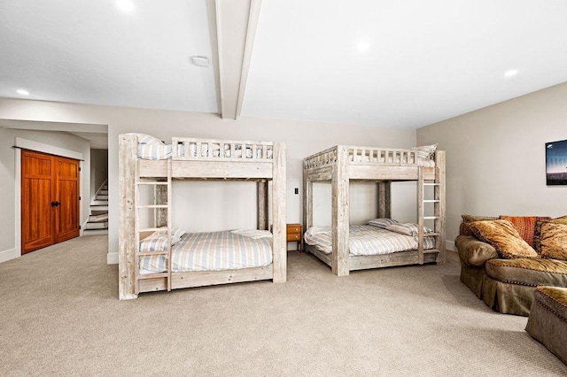 bedroom featuring beamed ceiling and carpet floors