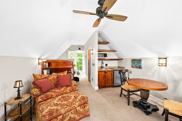 sitting room with vaulted ceiling, ceiling fan, sink, and light colored carpet