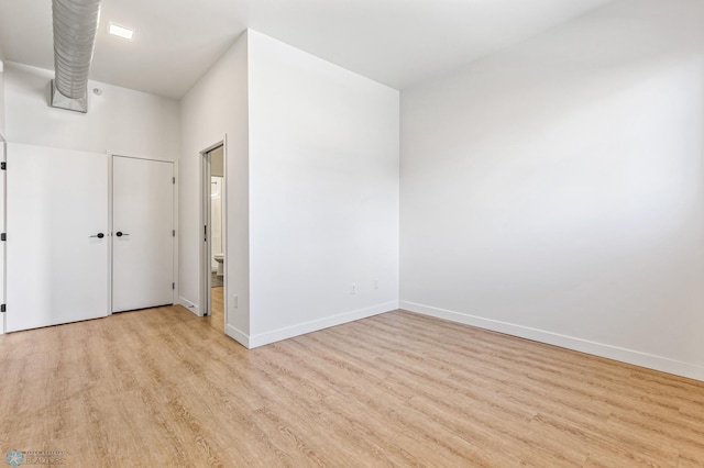 spare room with light hardwood / wood-style flooring