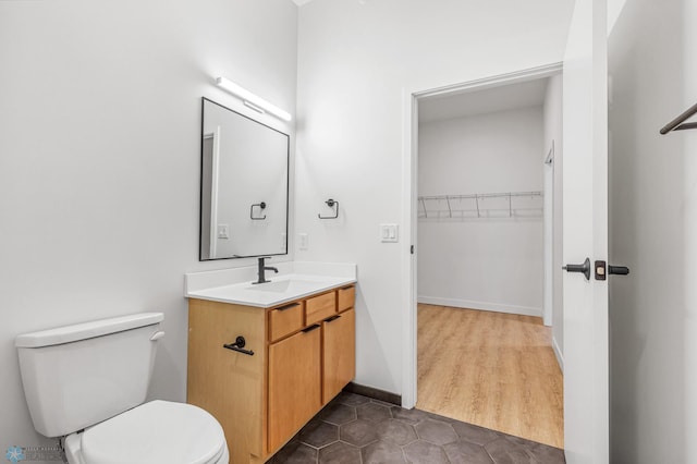 bathroom featuring hardwood / wood-style floors, vanity, and toilet