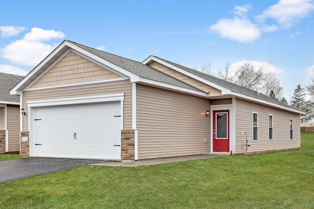 view of front facade with a front yard and a garage