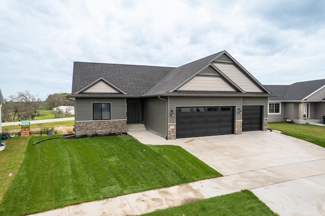 craftsman-style house featuring a garage and a front yard