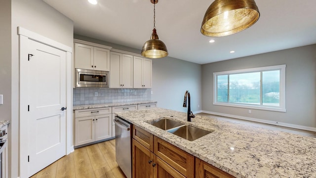 kitchen with light hardwood / wood-style flooring, white cabinetry, sink, and stainless steel appliances