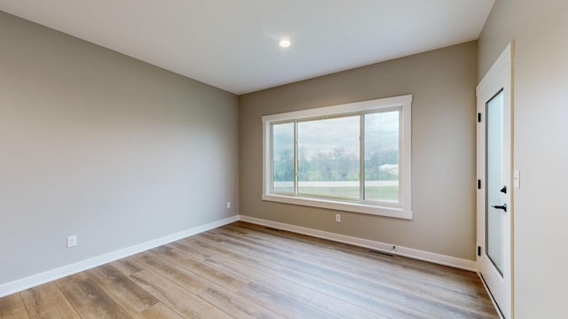 spare room with light wood-type flooring