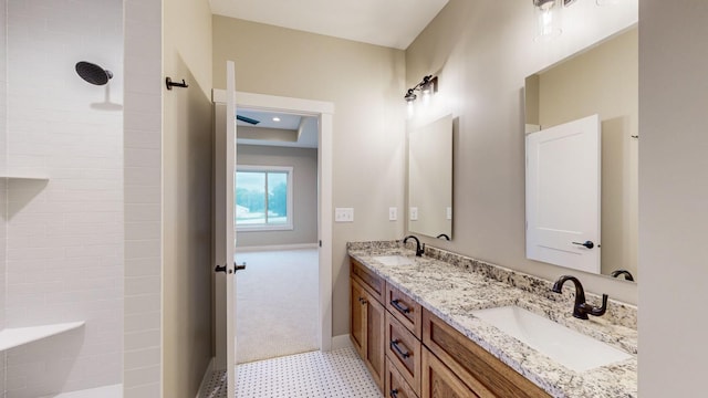 bathroom featuring walk in shower, vanity, and tile patterned floors