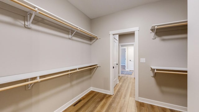 walk in closet featuring light hardwood / wood-style flooring