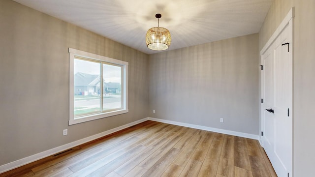 spare room featuring light wood-type flooring