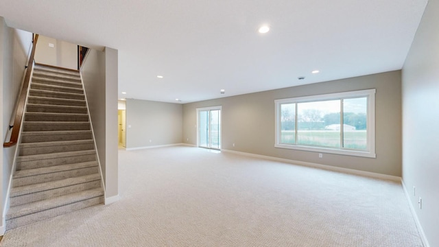 unfurnished room featuring light carpet