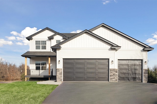 craftsman inspired home with a garage and a front yard