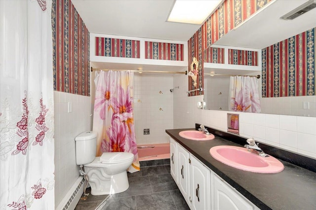 bathroom featuring toilet, vanity, a baseboard radiator, tile walls, and a shower with curtain