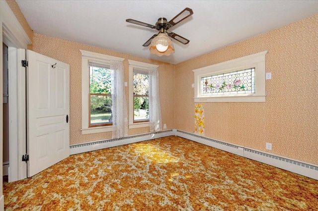 spare room featuring baseboard heating and ceiling fan