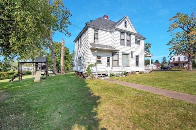 view of front of house featuring a playground and a front lawn