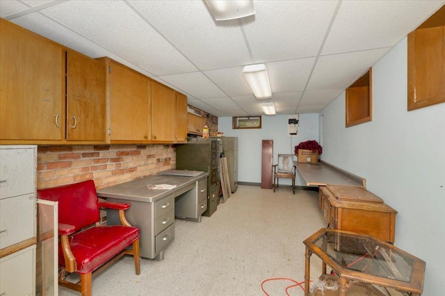 interior space with a paneled ceiling