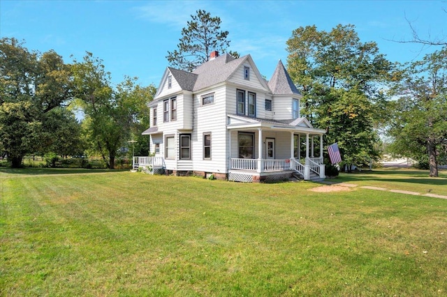 victorian-style house with a front yard and a porch