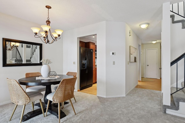 carpeted dining room featuring a chandelier