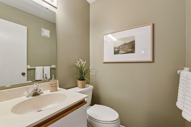 bathroom featuring toilet and vanity