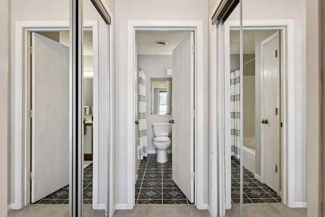 corridor with a textured ceiling