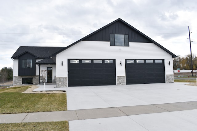 modern farmhouse style home with a garage and a front yard