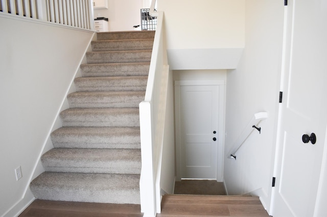 stairs with hardwood / wood-style floors