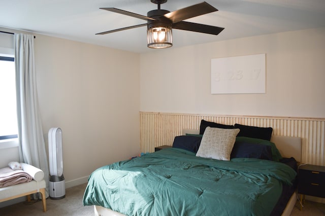 carpeted bedroom featuring multiple windows and ceiling fan