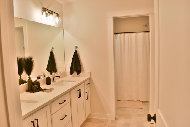 bathroom featuring vanity and curtained shower