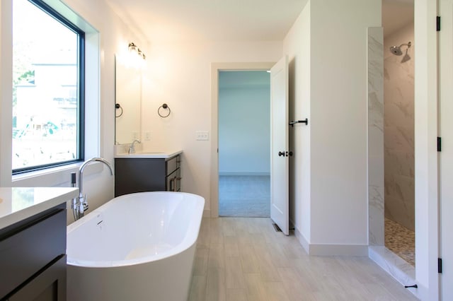 bathroom featuring separate shower and tub, vanity, and wood-type flooring