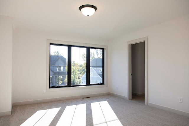 unfurnished room with light colored carpet