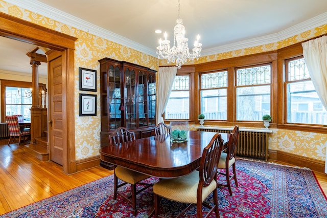 dining space with ornamental molding, hardwood / wood-style flooring, and radiator